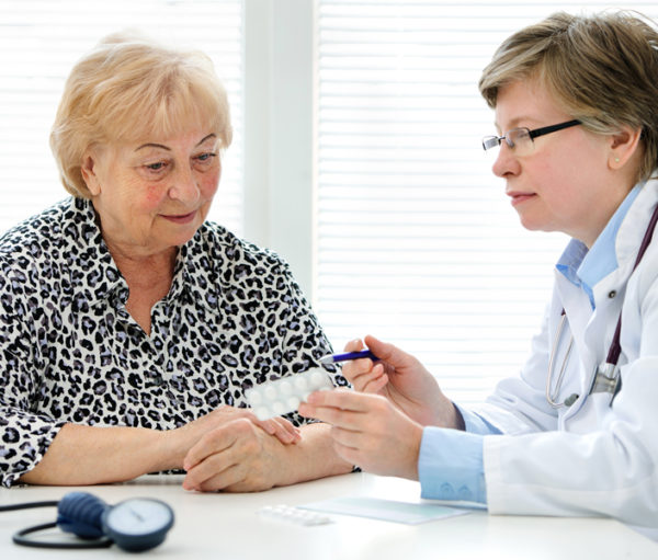 Doctor and senior patient discussing medication.